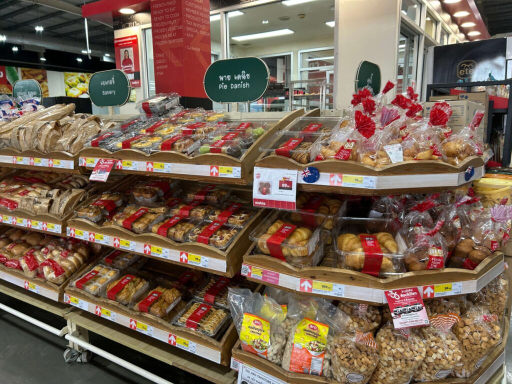 The bakery section inside Makro, showing a variety of breads and pastries on display shelves.
