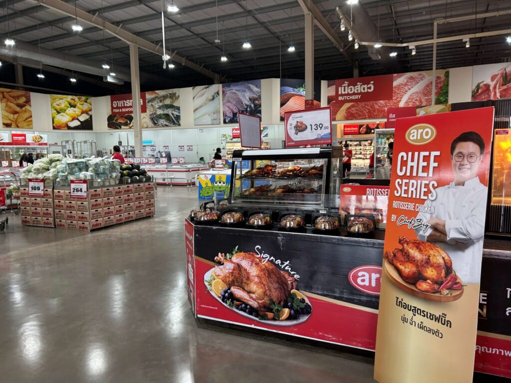 Display of freshly roasted rotisserie chickens and other prepared hot meals inside Makro Food Service