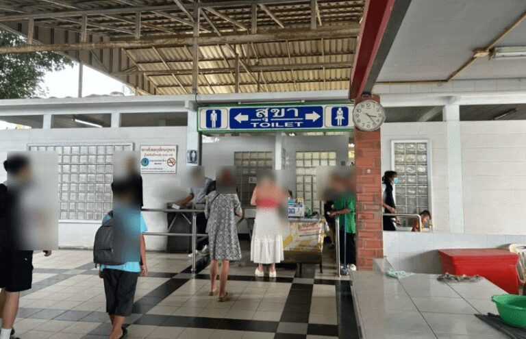 Sign pointing to restrooms (toilet) at North Pattaya Bus Terminal,