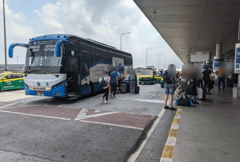 Passengers disembarking from a Roong Reuang Coach bus at the designated bus terminal at Suvarnabhumi Airport