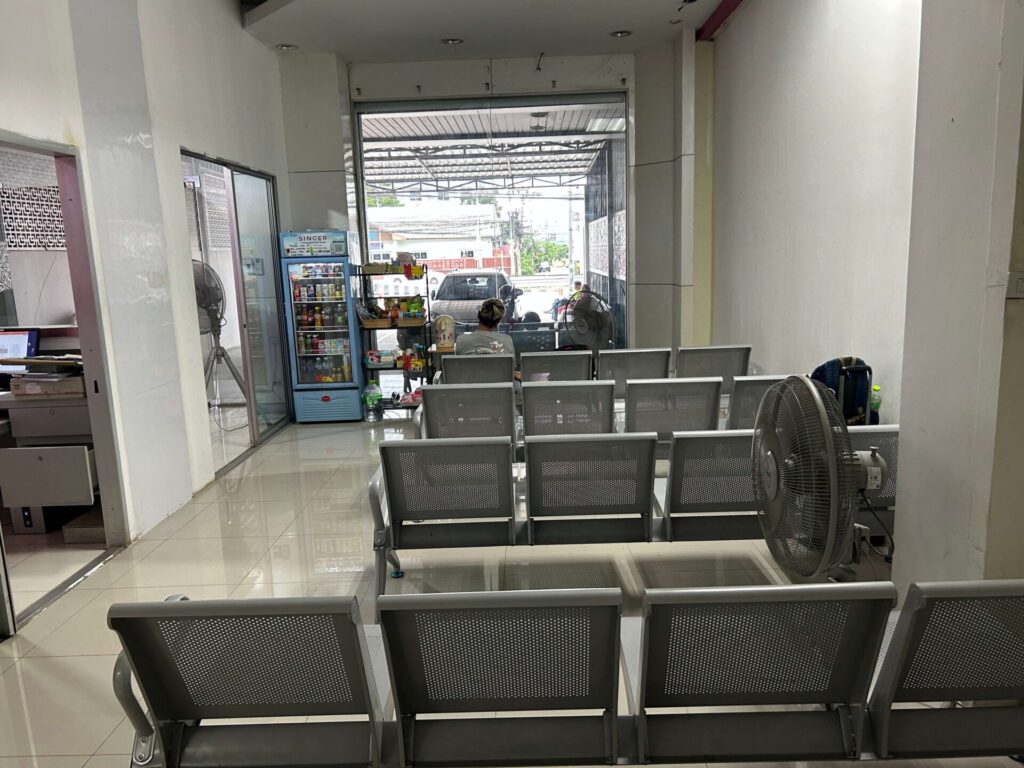 Waiting area inside the Bor Kor Sor office in Pattaya with metal chairs for passengers