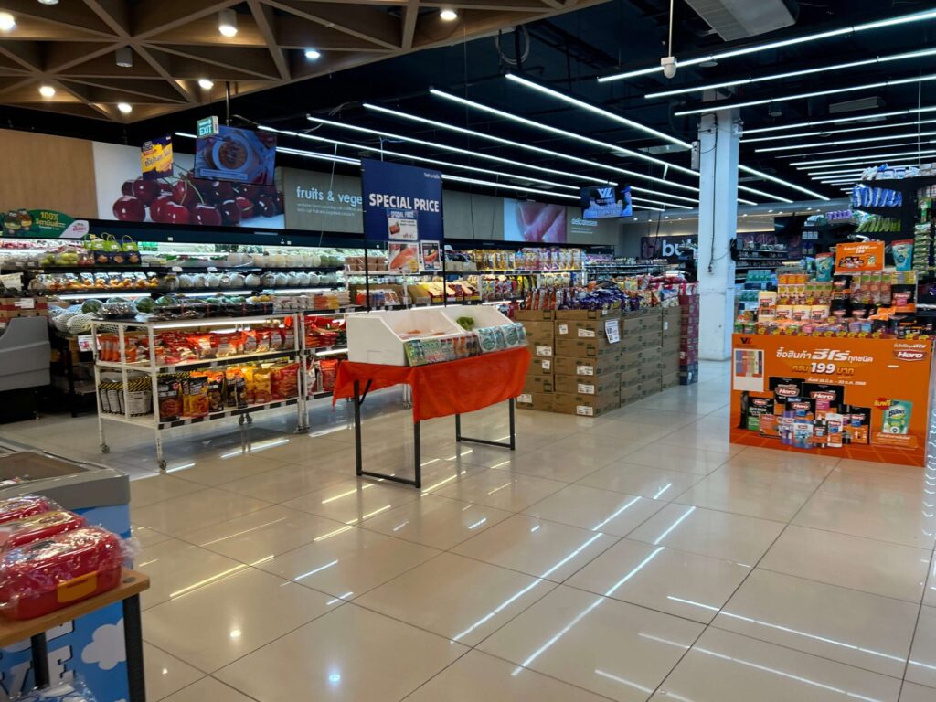 displaying wide aisles with a vast selection of groceries, fresh produce, and various packaged goods, ideal for bus travelers needing supplies.
