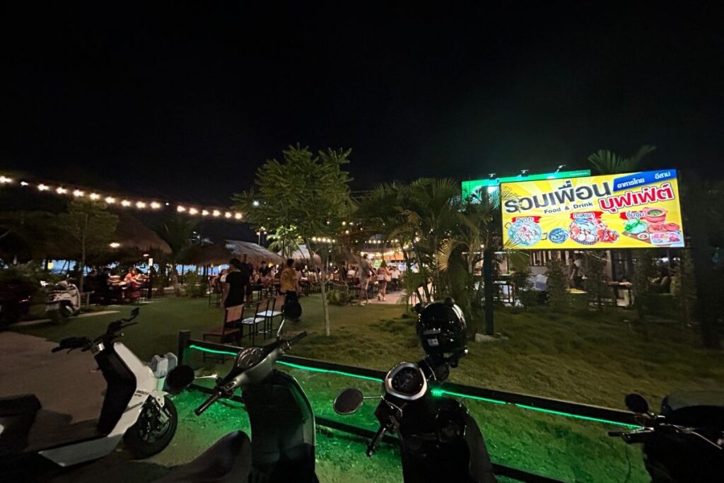 Outdoor garden-style Mookata buffet with cozy lights and palm trees