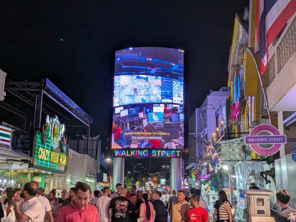 The vibrant and crowded nightlife scene near Walking Street in South Pattaya, showing bright neon signs and entertainment venues.