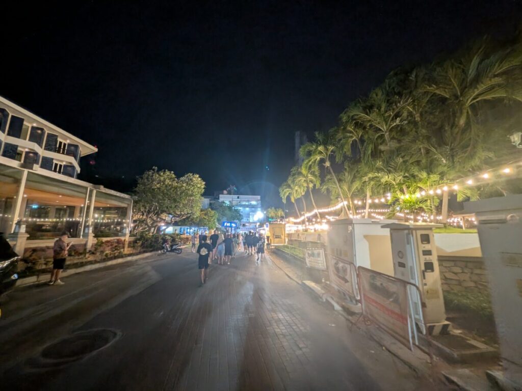 The night view of South Pattaya near the entrance of Walking Street, featuring bright signs, traffic, and the busy, vibrant atmosphere