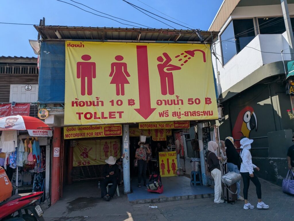 Sign showing toilet and shower facilities with prices at Koh Larn beach