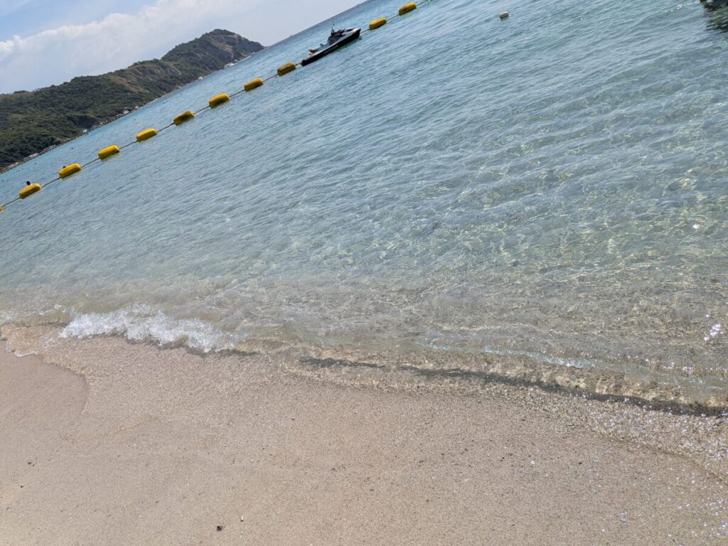 Close-up of clear turquoise water and white sand at Samae Beach, Koh Larn