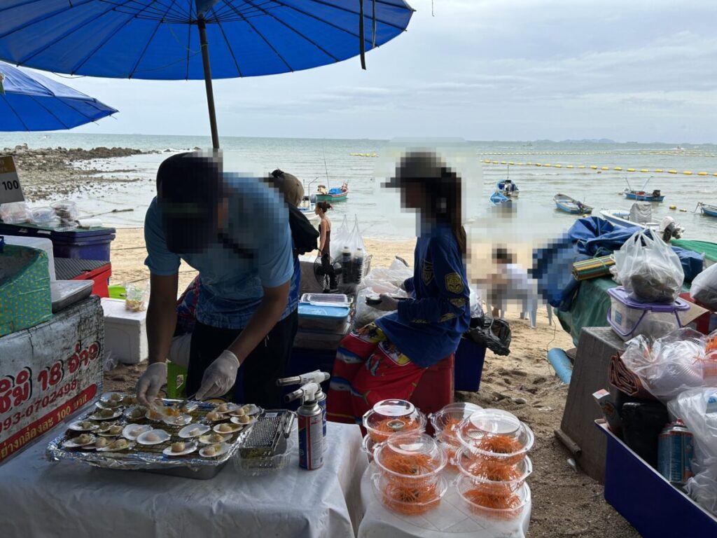 Beachside view from Sashimi Secret Beach with dining and ocean backdrop.