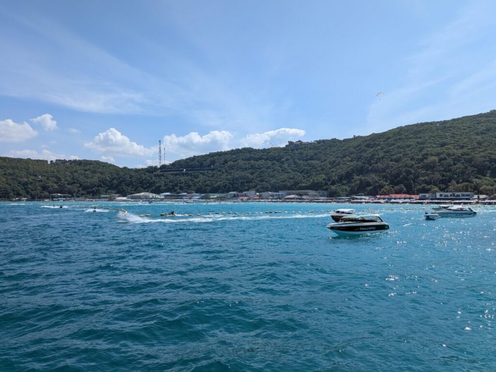 The stunning turquoise water and beach shoreline view captured from the end of Tawaen Beach Pier.