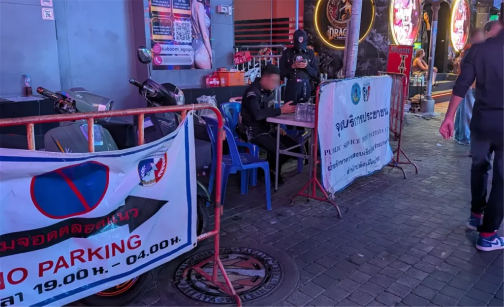 Pattaya Tourist Police at a public service point at night, ready to assist travelers.