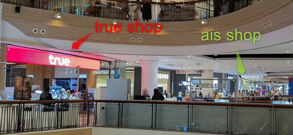 Modern interior of Central Pattaya mall showing official True and AIS flagship mobile stores on the 3rd floor.
