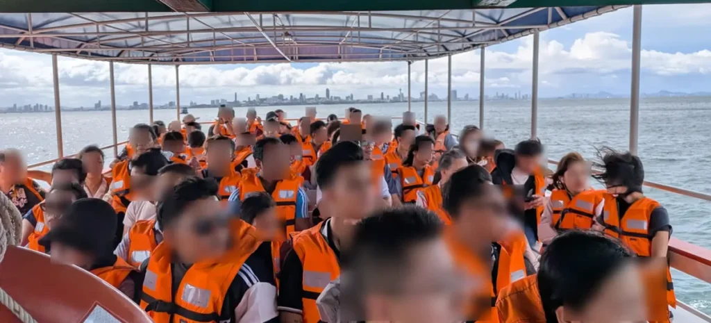 A packed public ferry heading to Koh Larn with everyone wearing life jackets.