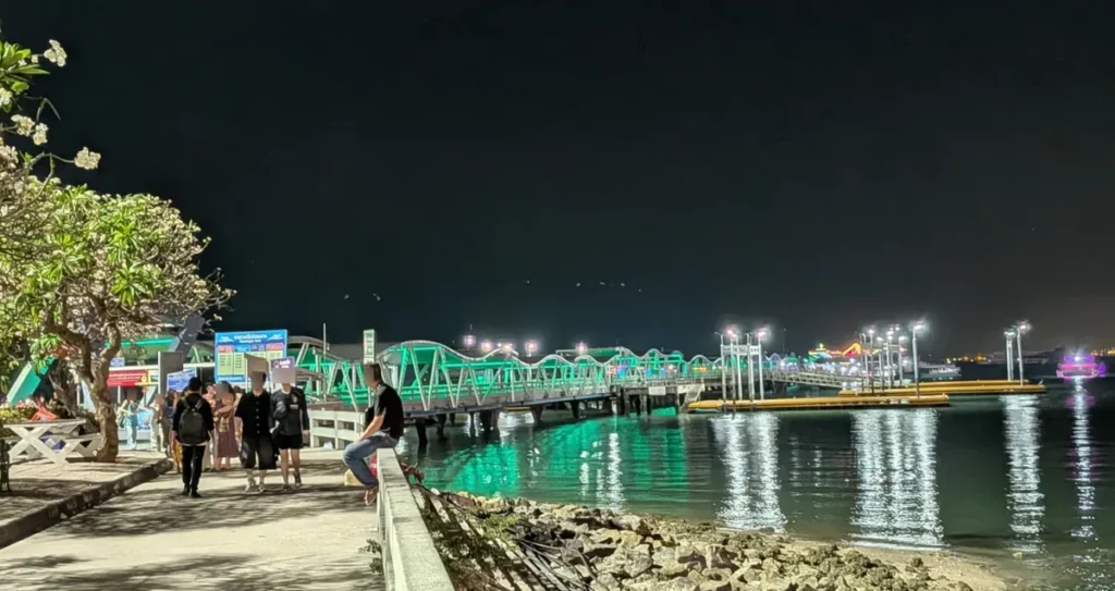 Green illuminated walkway of Bali Hai Pier at night, the ferry gateway to Koh Larn in South Pattaya.