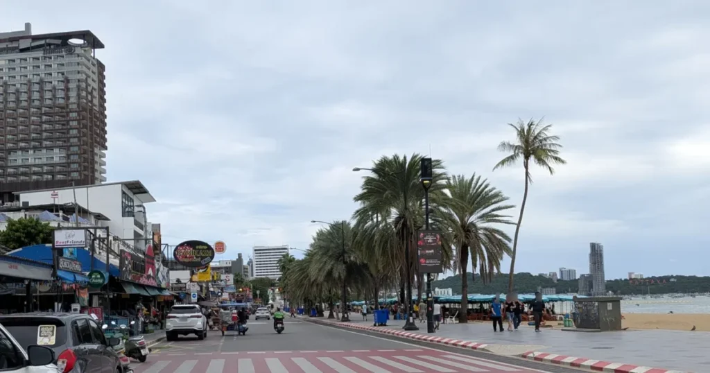 Wide sidewalks on Beach Road near Central Pattaya with palm trees and a crosswalk.