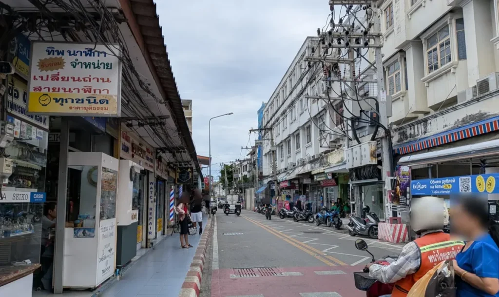 Local street scene along Soi Buakhao in Pattaya with shops, motorbikes, and everyday life.