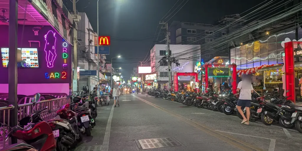 Tree Town Pattaya nightlife street with neon lights, bars, and evening crowds