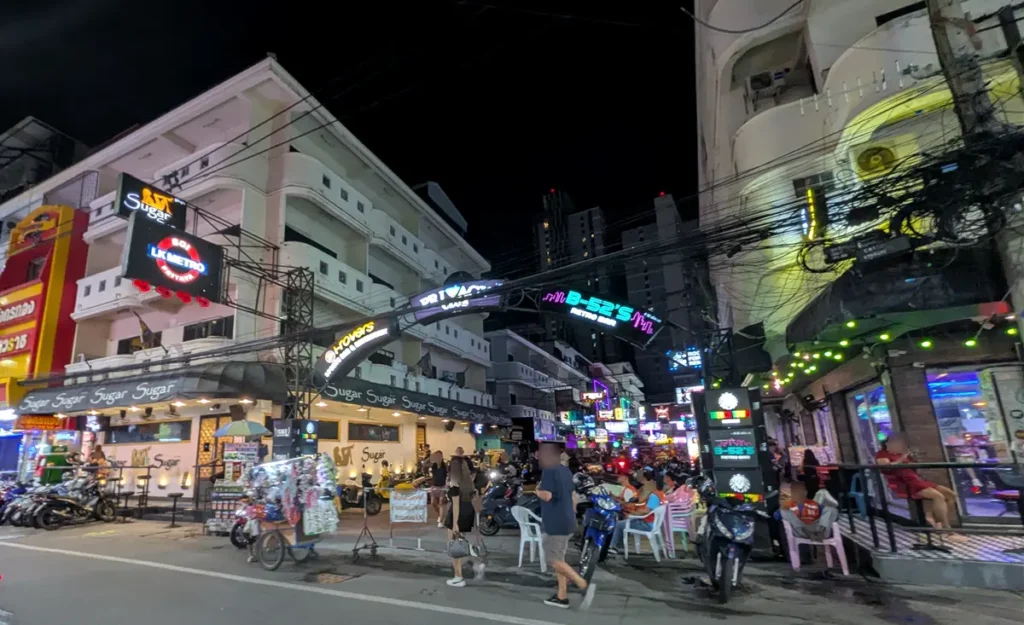LK Metro Pattaya nightlife district featuring neon signs, bars, and a busy evening street scene