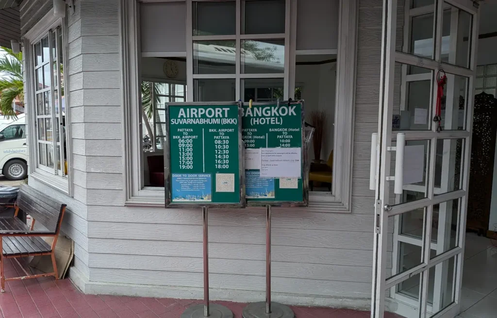 Bell Travel Service airport transfer and hotel pickup information boards at a Pattaya pickup point