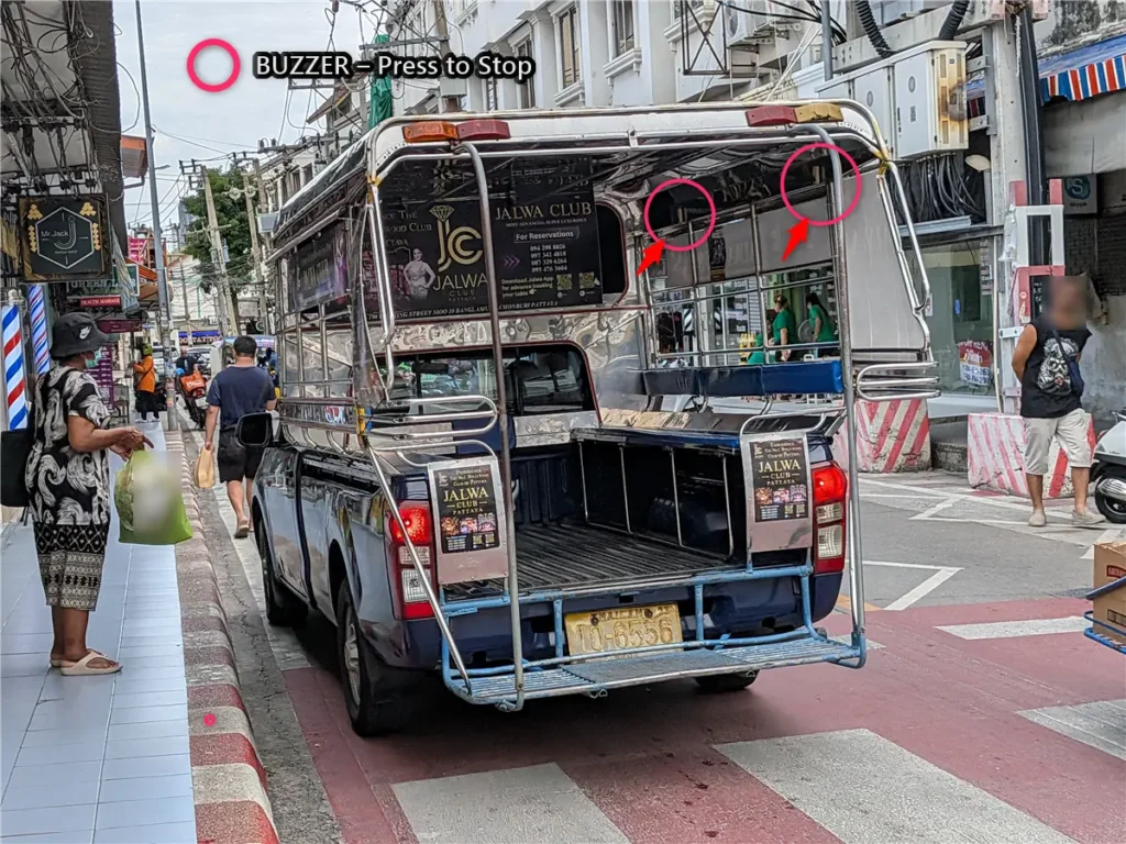 Rear passenger area of a Pattaya songthaew showing the buzzer used to request a stop