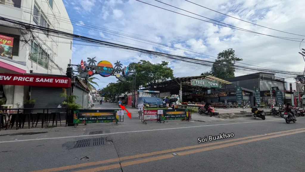Soi Buakhao entrance to Tree Town Pattaya showing the main overhead sign during the day