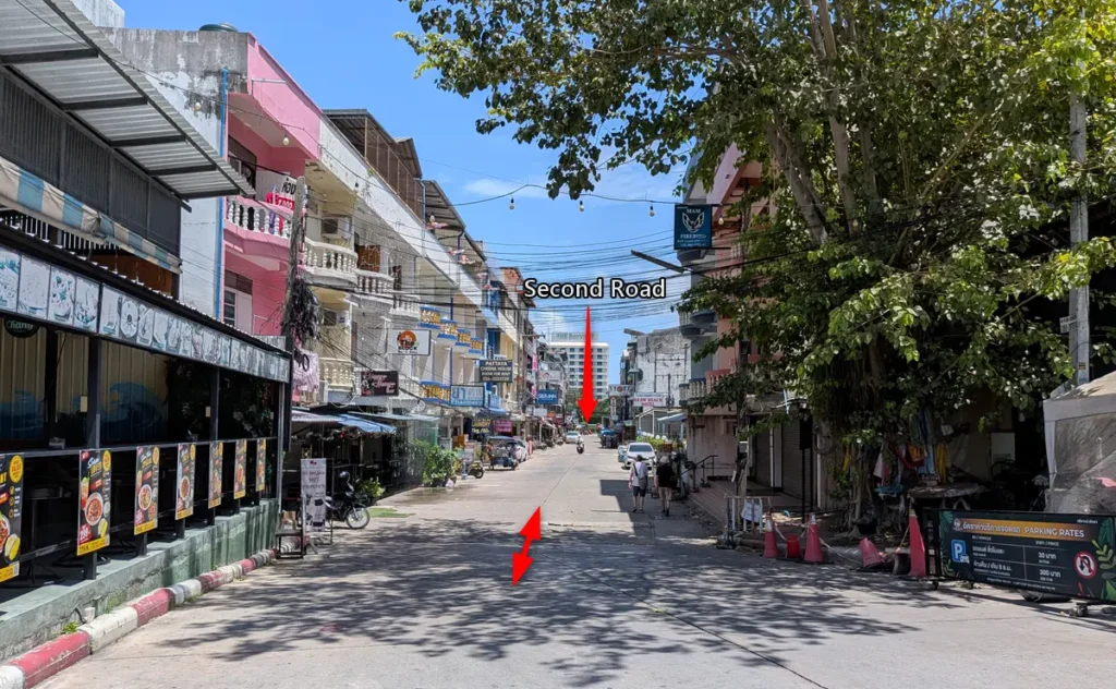Daytime view of the Tree Town shortcut alley leading toward Second Road
